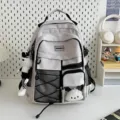 Utility style white backpack with black accents, multiple pockets and hanging doll for students. - Gray + Plaid Rabbit Pendant