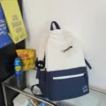 Color-blocking canvas backpack, minimalist student school bag with front zip pocket & plush charm. - Blue with Fur Ball