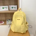 Lightweight yellow backpack with large capacity, waterproof fabric, and convenient side pockets. - Yellow