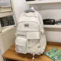 White multi-pocket school backpack with large capacity, durable fabric and comfortable straps. - White