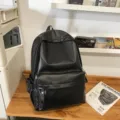 Minimalist black PU leather backpack for women, waterproof daily school computer bag. - Black