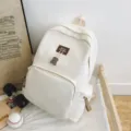 Minimalist solid color large capacity campus backpack with cute bear pendant for students use. - White