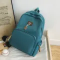 Solid color canvas school backpack with cute bear pendant, large capacity stylish student bag. - Lake Blue