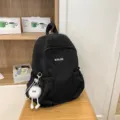 Black casual backpack for women, daily school bag and travel daypack with cute fluffy charm. - Black with Long Leg Ball