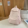 Pink casual school backpack for women, lightweight nylon bookbag with pockets for daily use - Pink