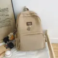 Casual khaki canvas school backpack with front pocket and cute bear pendant for daily use. - Dog Pendant Style / Khaki