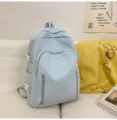 Detail shot of light blue cute school backpack with bow embroidery and side pocket buckles. - Blue