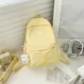 Casual yellow canvas backpack for women students, simple stylish school bookbag with bear pendant. - Bear Pendant / Yellow