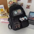 Black ita backpack with transparent window and anime badges for daily school and casual wear. - Black