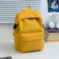 Solid yellow nylon casual backpack, stylish school bookbag for women and daily commuting. - Yellow