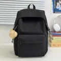 Solid color nylon casual backpack with cute bear pendant, stylish school bag for daily use. - Black with Bear Pendant