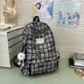 Japanese ins style black and white plaid backpack casual school bag with cute plush pendant for daily use - With Long-Legged Ball Pendant / Black
