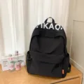 Casual black backpack for women, stylish student school bag with large capacity and design. - Black