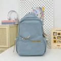 Light blue canvas backpack casual school daypack with front pocket and embroidery design. - Light Blue