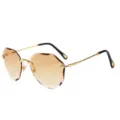 Modieuze montuurloze bruine gradient zonnebril met gouden gegraveerde pootjes. - Gouden Frame Champagne Lenzen