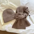 Detailed shot of cozy brown knit beanie and scarf set showcasing soft texture and warm fabric. - Two-Piece Set / Light Brown / One Size