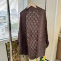 Detail shot of brown knitted hollow-out cardigan shawl with rhombus pattern, cozy indoor scene. - Mocha