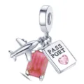 Silver travel dangle charm close-up, featuring airplane, pink suitcase and passport bead. - Color 003