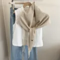 Beige knitted hollow shawl paired with white lace top and blue jeans, chic autumn winter cape. - Off White