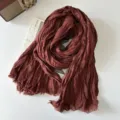 Detailed close up view of brown cotton linen pleated plaid scarf retro literary style - Brick Orange