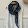 Detailed view of the dark grey tie-dye long thin scarf with unique wrinkles and soft texture. - Dark Blue