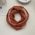Close-up view of the gradient tie-dye linen cotton scarf with soft wrinkles and folds. - Orange Beige Gradient