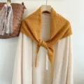 Detailed view of hollow knit wool triangular scarf, stylish solid color design, cozy texture. - Lemon Yellow