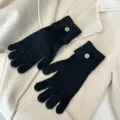 Detailed view of women knit touchscreen gloves with stylish button design in classic black. - One Size / Black