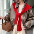 Detail shot of the women winter knit balaclava scarf combo worn with leather jacket style. - Red