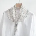 Floral print cotton triangular scarf detail showing fabric texture and cute design. - Beige