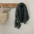 Detailed view of the vintage floral pleated green scarf hanging on a wooden wall hook. - Green