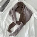 Close-up detail of color-blocked cotton linen scarf with delicate lace trim, stylish spring shawl. - Grey Coffee