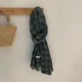 Detail view of the cotton linen plaid scarf, featuring soft texture and vintage grid pattern. - Green