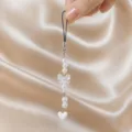 Pearl bow phone strap detail shot showing delicate beads, translucent bow and white heart. - Bowknot Heart Beaded Lanyard (5113 White) / White