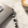 Detailed shot of a chic black and white pearl phone charm featuring a delicate bow and heart pendant. - Bowknot Heart Beaded Lanyard (5113 Black) / Black