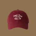 Burgundy baseball cap with white embroidered letters, detailed view of the stylish hat. - Adjustable / Burgundy