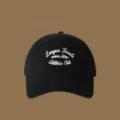 Classic black baseball cap with white embroidered text, stylish and versatile accessory for daily wear. - Adjustable / Black