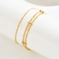 Cavigliera minimalista a doppio strato placcata in oro con perline e catena twist donna - Oro