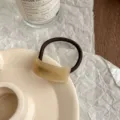 Detail shot of minimalist acetate curved hair tie, elegant brown elastic ponytail holder. - Khaki Pattern