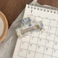 Detailed view of a small square acetate hair claw clip with retro oil painting blue pattern. - Oil Painting Blue