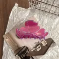 Close-up detail of the butterfly hair claw clip, premium purple pink resin design for half updo. - Deep purple