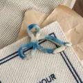 Blue and white acetate hair claw clip, elegant twisted bow design for women's daily hairstyles. - Blue & White Texture