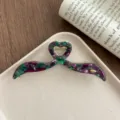 Detail view of the stylish irregular acetate hair claw clip with unique heart design. - Magic Purple
