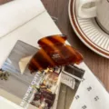 Tortoiseshell acetate hair claw clip detail shot, stylish brown medium shark clip accessory. - Flower Brown Stripe