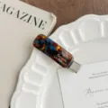 Korean style tortoise shell acrylic hair clip detail shot showing metallic duckbill clip and print. - Lake Blue Brown
