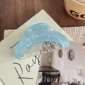 Detailed close-up of a stylish blue pearlescent acetate hair claw, aesthetic hair accessory. - Orchid Green