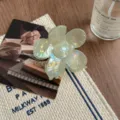 Transparent flower hair claw clip, light green iridescent resin shark clip detail view. - Green