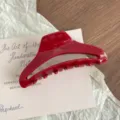 Red acetate hair claw clip detail shot, glossy finish with elegant gold lettering. - L / Red