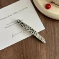 Elegant acetate hair clip with chic pattern and gold letters for daily fashion styling. - Black Dots