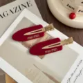 Detailed view of fashionable red acetate side hair clip with metallic gold duckbill design. - Pair (With Cardboard) / Cherry Red